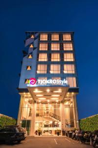 a tall building with a sign on the front of it at Tjokro Style Yogyakarta in Yogyakarta