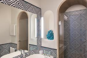 a bathroom with two sinks and a mirror at Pazziella Garden & Suites in Capri