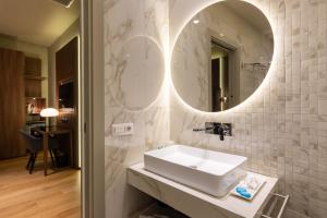 a bathroom with a sink and a mirror at ELICAL Exclusive Private Suites in Rome
