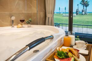 a tray of food in a bath tub with a plate of food at Sun and Moon Resort in Seogwipo