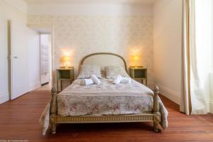 a bedroom with a bed with two lamps on two tables at L'Orée du Lac - Formule Gîte in Marcenay