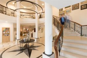 a man walking down the stairs in a building at Vju Hotel Rügen in Göhren