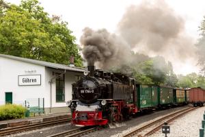 a steam train is coming down the tracks at Vju Hotel Rügen in Göhren
