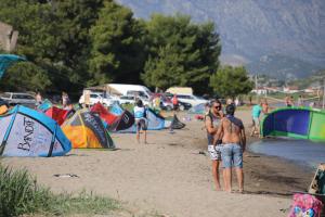 a group of people standing on a beach with tents at Holiday house with a swimming pool Opuzen, Neretva Delta - Usce Neretve - 8818 in Opuzen