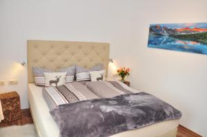 a bedroom with a bed with a painting on the wall at Appartment Haus Birgit in Seefeld in Tirol