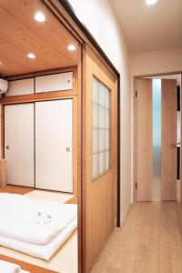 a room with a door leading to a bedroom at HANASTAY花渓居 · 柳（YANAGI) in Osaka