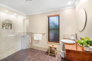 a bathroom with a sink and a shower at Mudjimba Escape-pet friendly, luxury villa w/ pool in Mudjimba