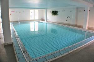 a large swimming pool in a building at Residenz Kormoran 1 0 in Cuxhaven