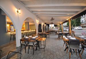 an empty restaurant with wooden tables and chairs at Lale Otel in Turunç