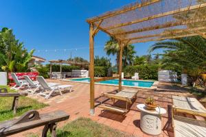 un patio con pergolato in legno e una piscina di Villa Relax a Galatone