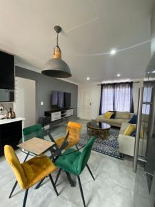 a living room with a table and chairs and a couch at Castle45 in Roodepoort