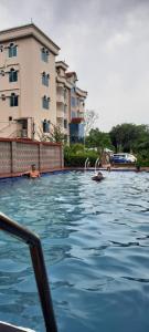 a swimming pool in front of a building at Grand Selim Resort & Tour – GSRT in Sreemangal