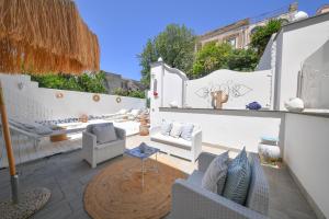 a patio with couches and chairs and a table at Queen Suite - Luxury Rooms in Ischia