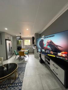 a living room with a large flat screen tv at Castle45 in Roodepoort