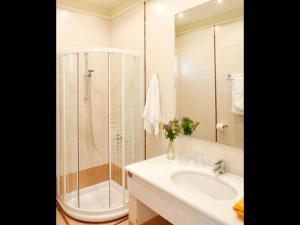 a white bathroom with a shower and a sink at Villa Ares with private pool and a spectacular seaview 150m from the beach in Istron +13 photos