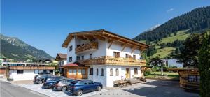a building with cars parked in a parking lot at Beim Franz in Lermoos