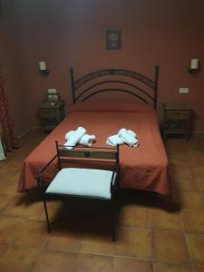 a bedroom with a bed with two towels on it at Hostal La Plata in Oropesa