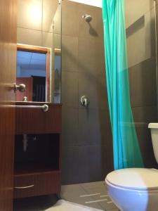 uma casa de banho com um WC e um chuveiro em Hotel Ummagumma em Montañita