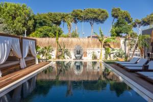 a swimming pool with lounge chairs and a resort at ASHA ALAÇATI in Çeşme