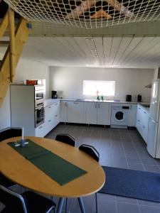 A kitchen or kitchenette at Pensionat Strandhuset i Abbekås