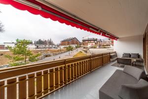 a balcony with a view of a city at In the heart of Crans, fireplace and parking in Crans-Montana