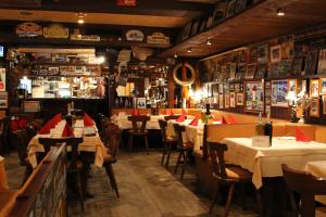 a restaurant with tables and chairs in a room at Hotel Am Tiergarten in Nürburg +42 photos
