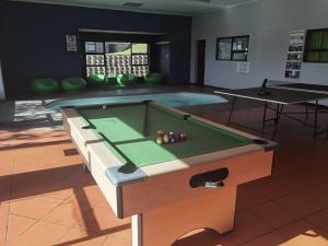 a room with a pool table and a swimming pool at Eagles Nest in Sedgefield