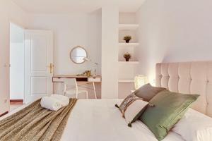 a bedroom with a large white bed with a white headboard at Quiet Marina Gardens Apartment in A Coruña