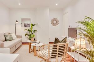 a living room with a couch and a table at Quiet Marina Gardens Apartment in A Coruña