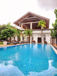 a swimming pool in front of a building at Hotel Cloud 9 Negombo in Negombo