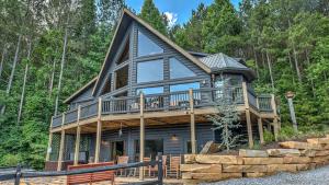 a large wooden house with a wrap around deck at Black Bear Ridge in Ellijay