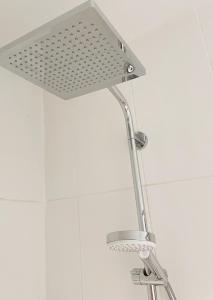 a shower with a shower head in a bathroom at Haus Edeltraut in Bad Mitterndorf
