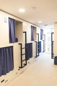 a row of clothes racks in a dressing room at Hostel Villa Miguela in Santander