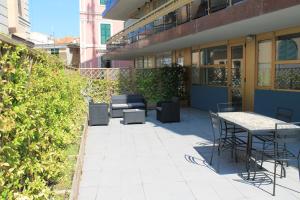 a patio with chairs and tables in a building at Da Mariella case vacanze con terrazzo in Sanremo