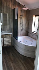a large bathroom with a tub and a sink at ANTİGONİA BUTİK OTEL in İznik