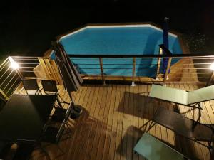 a pool on the deck of a boat at night at Maison typique périgourdine avec piscine in Paulin