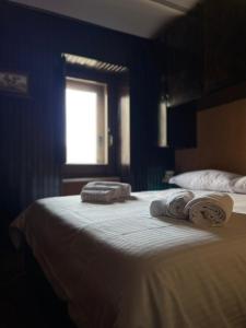a bedroom with a large bed with towels on it at Casa Belvedere Sant’Anna in Rivisondoli