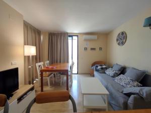 a living room with a couch and a table at Calafell Sant Antoni in Calafell