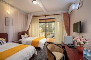 Krevet ili kreveti u jedinici u okviru objekta Entebbe Traveller's Hotel