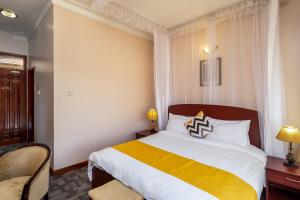 Krevet ili kreveti u jedinici u okviru objekta Entebbe Traveller's Hotel
