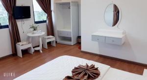 Postel nebo postele na pokoji v ubytování Minh Quan Hotel