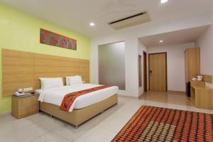 a bedroom with a large bed in a room at GINGER Noida City Center in Noida