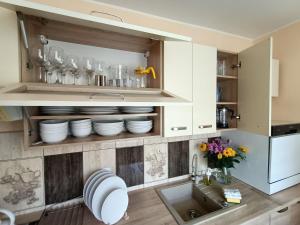 a kitchen with white cabinets and a sink at Dom w sercu Gdańska in Gdańsk