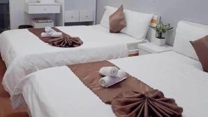 Postel nebo postele na pokoji v ubytování Minh Quan Hotel