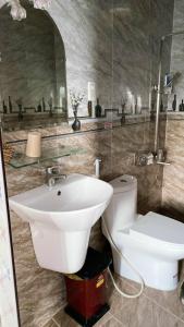 a bathroom with a sink and a toilet at Minh Quan Hotel in Da Lat