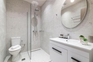 a bathroom with a toilet and a sink and a mirror at Bella Vacanza Studios in Zakynthos Town