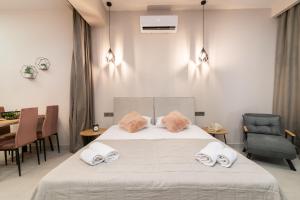 a bedroom with a bed with two pillows on it at Bella Vacanza Studios in Zakynthos