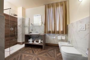 een badkamer met een wastafel, een toilet en een bad bij Palazzo Martellini Residenza d'epoca in Florence