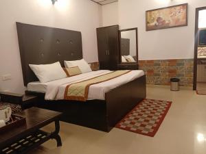 a bedroom with a large bed in a room at New Orange Tree Classic Fall in Mussoorie with pool & parking in Mussoorie +105 photos