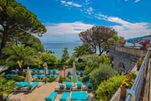 vista sulla piscina in un resort con sedie e ombrelloni di Amadria Park Hotel Milenij a Opatija
